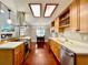 Bright kitchen features stainless appliances, wood cabinets and countertops, and skylights for natural light at 5724 Pitch Pine Dr, Orlando, FL 32819