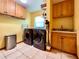 The laundry room boasts a modern washer and dryer, ample cabinet space, and tile floors for convenience at 5724 Pitch Pine Dr, Orlando, FL 32819