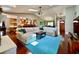 Bright living room with a vaulted ceiling, hardwood floors, comfortable seating, and an open layout at 5724 Pitch Pine Dr, Orlando, FL 32819