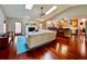 Open-concept living room featuring hardwood floors, skylights, and a seamless transition to the kitchen at 5724 Pitch Pine Dr, Orlando, FL 32819