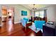 Living room featuring hardwood floors, stylish seating, and seamless flow to the kitchen at 5724 Pitch Pine Dr, Orlando, FL 32819