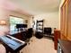 Bright office space featuring a large desk, dual monitors, keyboard, guitar, and ample shelving for storage and decor at 5724 Pitch Pine Dr, Orlando, FL 32819