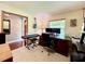 The office space with a desk, monitors, keyboard, guitar, wood floors, and bright light is perfect for working at 5724 Pitch Pine Dr, Orlando, FL 32819