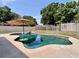 Backyard pool with unique shape, umbrella, and lush landscaping for a relaxing atmosphere at 5724 Pitch Pine Dr, Orlando, FL 32819