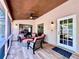 Charming screened patio with comfortable seating, ceiling fan, and outdoor lighting at 5724 Pitch Pine Dr, Orlando, FL 32819