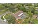 An aerial view of a property showcasing a screened-in pool and mature trees at 603 S Sweetwater Blvd, Longwood, FL 32779