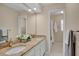 Bright bathroom featuring double vanity with granite countertop and decorative mirror at 603 S Sweetwater Blvd, Longwood, FL 32779