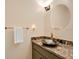 Bathroom featuring vanity with granite countertop, modern faucet, and decorative mirror at 603 S Sweetwater Blvd, Longwood, FL 32779