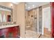 Bathroom with glass shower, granite countertops, and cherry wood vanity at 603 S Sweetwater Blvd, Longwood, FL 32779