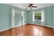 Bedroom with hardwood floors, two windows with great natural light, and a ceiling fan at 603 S Sweetwater Blvd, Longwood, FL 32779