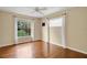 Bedroom with hardwood floors, neutral colored walls, and bright window with outdoor view at 603 S Sweetwater Blvd, Longwood, FL 32779