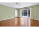 Bright bedroom with hardwood floors and sliding glass doors to the pool at 603 S Sweetwater Blvd, Longwood, FL 32779