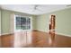 Light filled bedroom with hardwood floors and sliding glass doors to the backyard at 603 S Sweetwater Blvd, Longwood, FL 32779