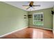 Bedroom with hardwood floors, built in shelving, and green walls at 603 S Sweetwater Blvd, Longwood, FL 32779