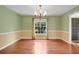 Classic dining room features wood floors, decorative chandelier, and sunlit window at 603 S Sweetwater Blvd, Longwood, FL 32779