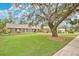 Ranch-style home with large front yard and mature shade tree at 603 S Sweetwater Blvd, Longwood, FL 32779