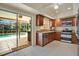 Well-equipped kitchen with stainless steel appliances and views of the pool area at 603 S Sweetwater Blvd, Longwood, FL 32779