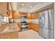 Modern kitchen with stainless steel appliances, granite counters, and wood cabinetry at 603 S Sweetwater Blvd, Longwood, FL 32779