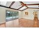 Bright living room with hardwood floors and sliding glass doors to the screened pool area at 603 S Sweetwater Blvd, Longwood, FL 32779