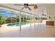 Screened-in pool area with large patio, ceiling fans, and comfortable outdoor seating at 603 S Sweetwater Blvd, Longwood, FL 32779