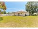 Spacious backyard with a well-maintained lawn, privacy fence, and mature trees at 620 Unabelle Ave, Holly Hill, FL 32117