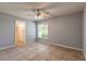 Bedroom with tile flooring, ceiling fan, window and ensuite bathroom at 620 Unabelle Ave, Holly Hill, FL 32117