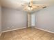 Bedroom featuring tile flooring, ceiling fan, and closet space at 620 Unabelle Ave, Holly Hill, FL 32117
