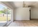 Bright dining area with sliding glass doors leading to the backyard and chandelier lighting at 620 Unabelle Ave, Holly Hill, FL 32117