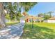 Charming home with a well-manicured front lawn, a red door, and an attached garage at 620 Unabelle Ave, Holly Hill, FL 32117