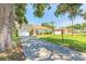 Inviting home exterior with a well-kept lawn, an attached garage, and a red front door at 620 Unabelle Ave, Holly Hill, FL 32117