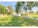 Single-story home with a well-manicured lawn and a side view of the attached garage at 620 Unabelle Ave, Holly Hill, FL 32117