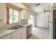 Bright kitchen features stainless steel appliances, tile floors and a sliding glass door at 620 Unabelle Ave, Holly Hill, FL 32117