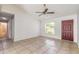 Open-concept living room featuring tile floors, a ceiling fan, and a view to the entrance door at 620 Unabelle Ave, Holly Hill, FL 32117