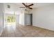 Bright living room with tile flooring, ceiling fan, and sliding glass doors to the backyard at 620 Unabelle Ave, Holly Hill, FL 32117