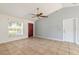 Bright living room with tile flooring, ceiling fan, and a view to the entrance door at 620 Unabelle Ave, Holly Hill, FL 32117