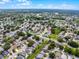 An aerial view showcases a well-planned community with lush greenery, ponds, and neatly arranged homes at 754 Birgham Pl, Lake Mary, FL 32746