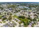 An aerial view features homes nestled around a picturesque lake, offering a serene and desirable living environment at 754 Birgham Pl, Lake Mary, FL 32746