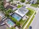 Aerial view showcasing a home with a screened pool and a smaller pool, surrounded by well-manicured landscaping at 754 Birgham Pl, Lake Mary, FL 32746