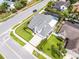 Aerial view of a home, showcasing its layout, screened-in pool, surrounding greenery, and neighborhood at 754 Birgham Pl, Lake Mary, FL 32746