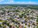 An aerial view of a suburban neighborhood with mature trees and well-maintained houses on a sunny day at 754 Birgham Pl, Lake Mary, FL 32746