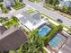 Aerial view showcasing a home with a screened pool and a smaller pool, surrounded by well-manicured landscaping at 754 Birgham Pl, Lake Mary, FL 32746