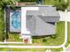 Overhead aerial view of a home with a screened-in pool, well-maintained lawn, and modern roof at 754 Birgham Pl, Lake Mary, FL 32746