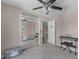 Cozy bedroom with mirrored closet, ceiling fan, and open doorway leading to the staircase at 754 Birgham Pl, Lake Mary, FL 32746
