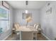 Bright dining room with a large window and an elegant dining table at 754 Birgham Pl, Lake Mary, FL 32746