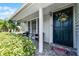 Inviting front porch with seating, a decorative wreath, and a well-manicured garden at 754 Birgham Pl, Lake Mary, FL 32746