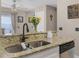Kitchen bar area featuring granite countertops, a sink, and access to a stainless steel dishwasher at 754 Birgham Pl, Lake Mary, FL 32746
