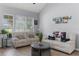 Bright living room featuring large windows, comfortable sofas, and a modern coffee table at 754 Birgham Pl, Lake Mary, FL 32746