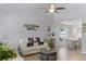 Bright living room featuring vaulted ceilings, ceiling fan and stylish furnishings at 754 Birgham Pl, Lake Mary, FL 32746