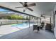 Spacious covered patio with ceiling fans and seating, offering a view of the inviting screened-in pool and backyard at 754 Birgham Pl, Lake Mary, FL 32746