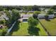 Aerial view of a well-manicured backyard, patio, mature trees, and the surrounding residential neighborhood at 7911 Murcott Cir, Orlando, FL 32835